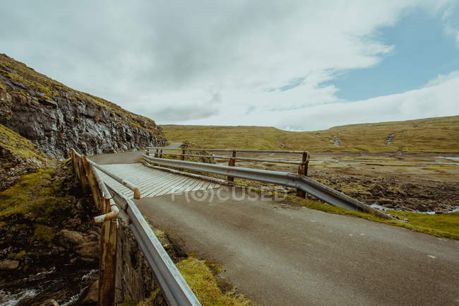 Scenic view of bridge in misty highlands — Stock Photo