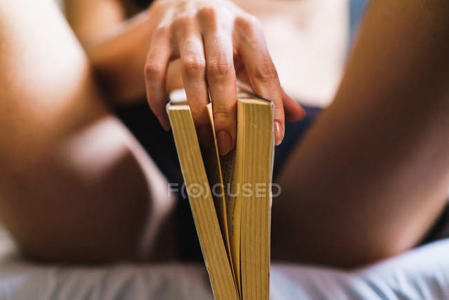 crop female hand provocative posing with book stock photo 176675298