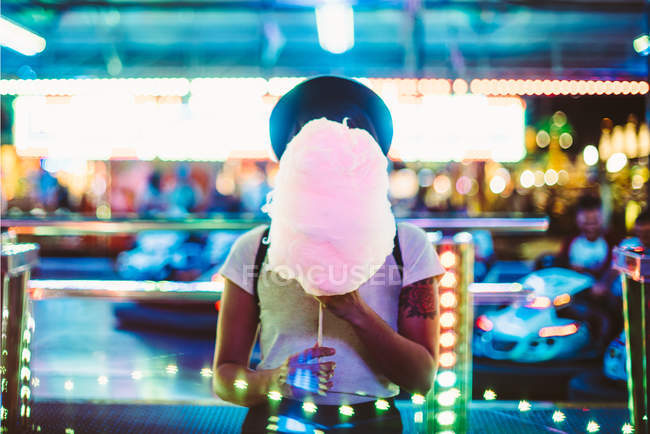 Front view of woman covering face with sugar cloud — Stock Photo