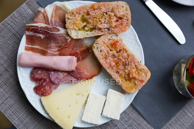 Variety of snacks on plate at cafe table — Stock Photo