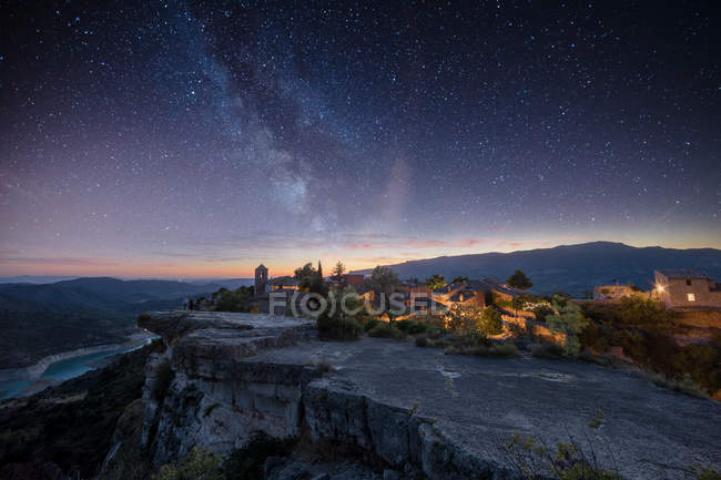 View of village located on cliffs over sunset sky — Stock Photo