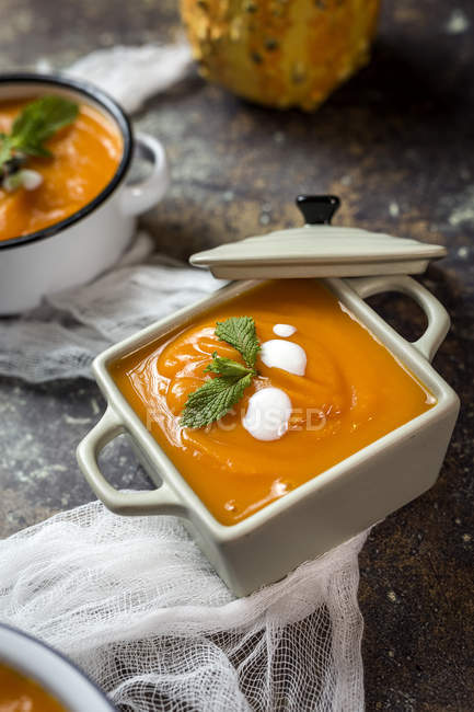 Close up view of cream of pumpkin in bowls on white gauze — Stock Photo