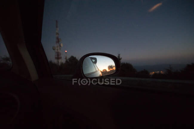 Car rearview mirror at sunset — Stock Photo