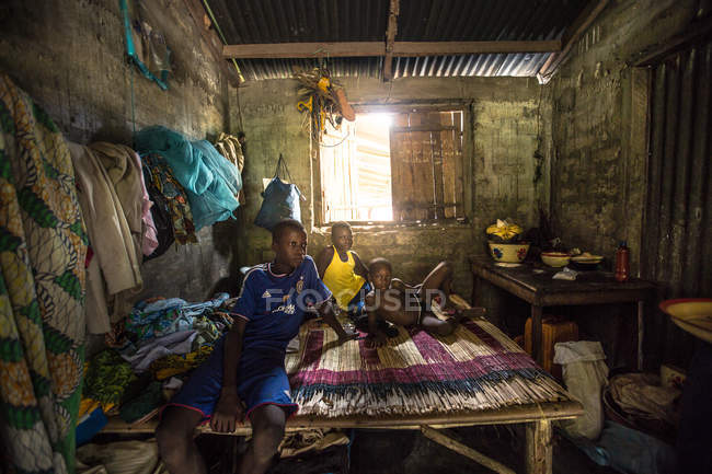 BENIN, AFRICA - AUGUST 31, 2017: African children posing on bed at home — Stock Photo