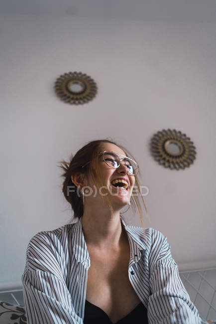 High angle portrait of laughing brunette girl in stylish eyeglasses — Stock Photo