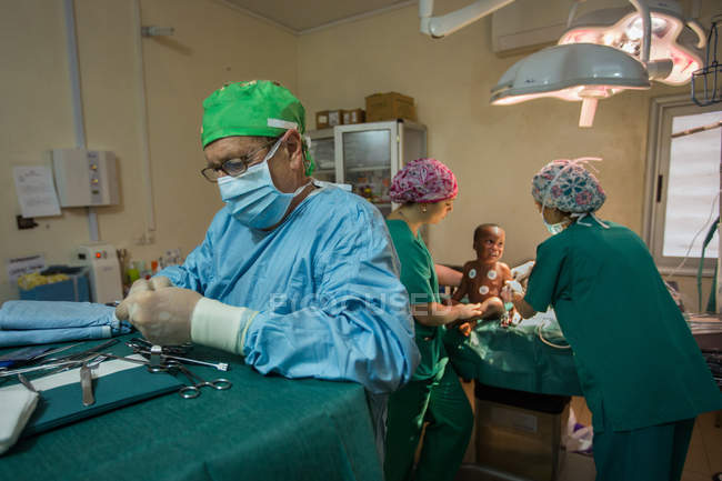 Benin, Afrika - 31. August 2017: Kinderchirurg bereitet sich darauf vor, kleinen Jungen im Krankenhaus zu operieren. — Stockfoto