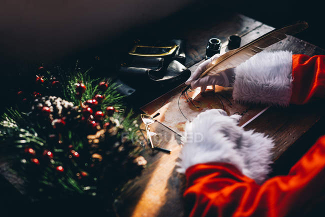 Crop of Santa Claus planing on world map gift delivery for Christmas. — Stock Photo