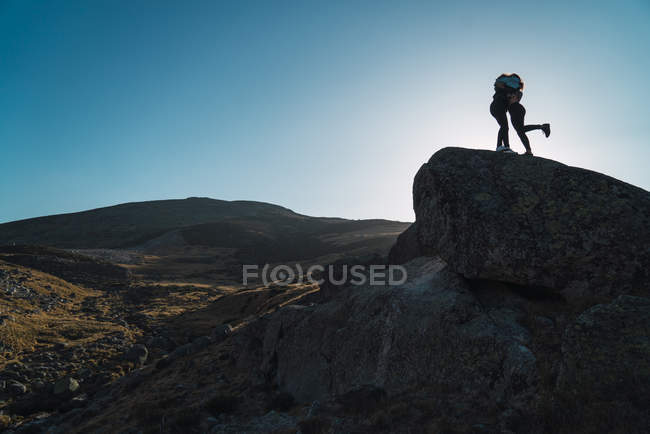 Scenic landscape of valley with embracing women on rock — Stock Photo