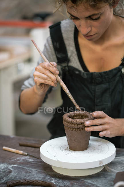 Portrait of potter working with clay and making pot — Stock Photo