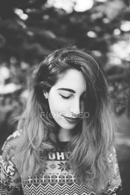 Beautiful girl with piercing looking down — Stock Photo