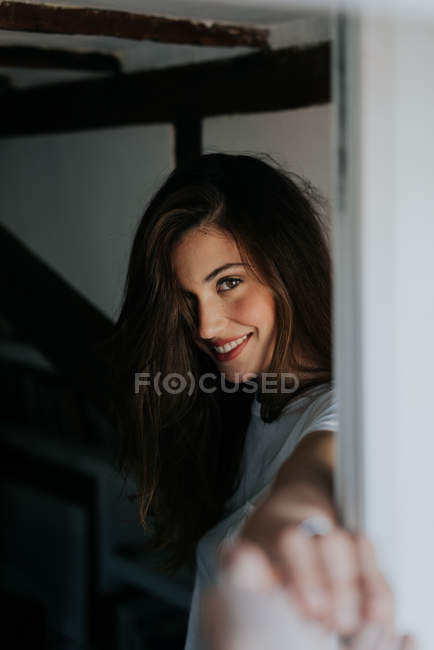 Brunette girl flirting with camera and outstretching hand — Stock Photo