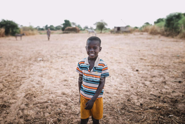 Goree, Senegal- December 6, 2017: Portrait of little smiling boy at field — Stock Photo