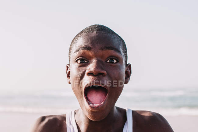 Yoff, Senegal- December 6, 2017: Portrait of expressive teenager looking at camera with great astonishment. — Stock Photo