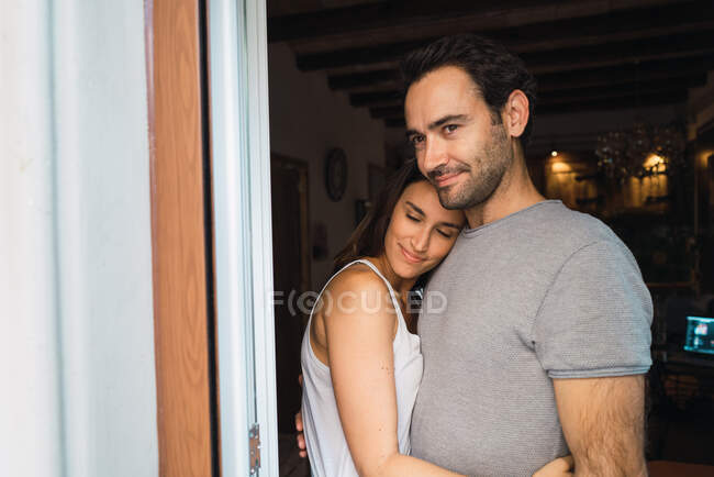 Loving parents embracing at home — Stock Photo