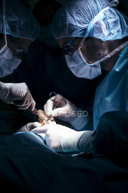 Portrait de deux chirurgiens opérant un patient à l'hôpital — Photo de stock