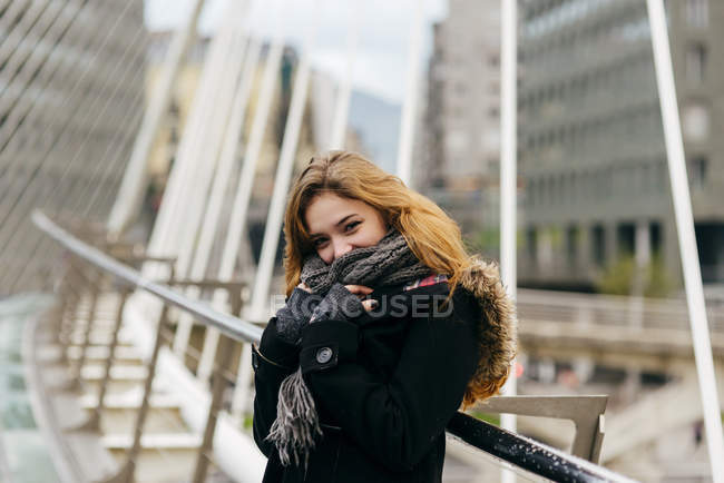 Portrait of blonde woman posing playfully on bridge — Stock Photo
