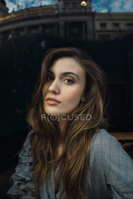 Portrait of sensual brunette woman posing in cafe behind window — Stock Photo