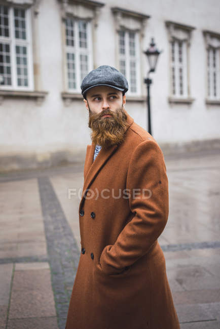 Portrait of stylish bearded man walking in city — Stock Photo