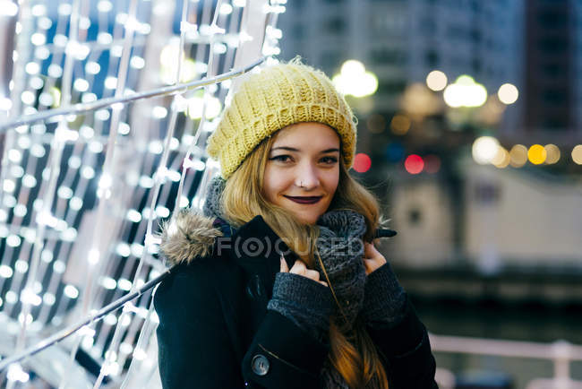 Portrait smiling woman posing at illumination and looking at camera — Stock Photo
