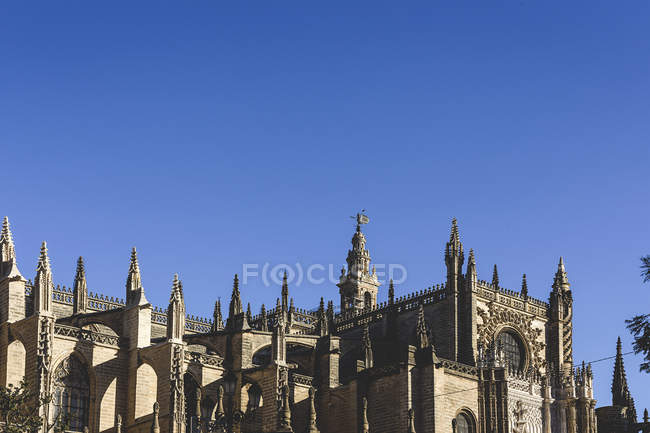 Crop exterior of ornate house with towers and spires against sky — Stock Photo