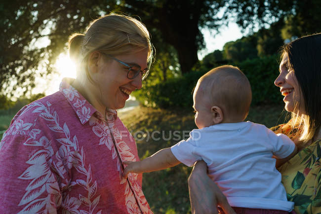 Vista lateral de la madre con niño en el parque - foto de stock