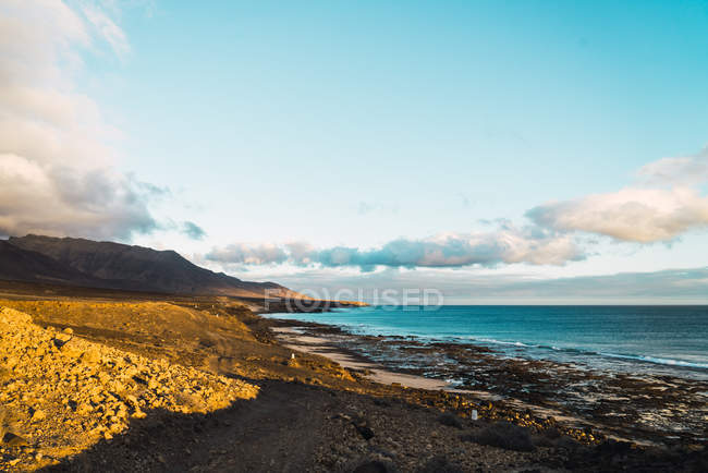 Сценический вид береговой линии океана в солнечный день — стоковое фото