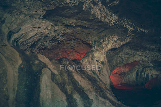View to illuminated ways and holes in cave. — Stock Photo