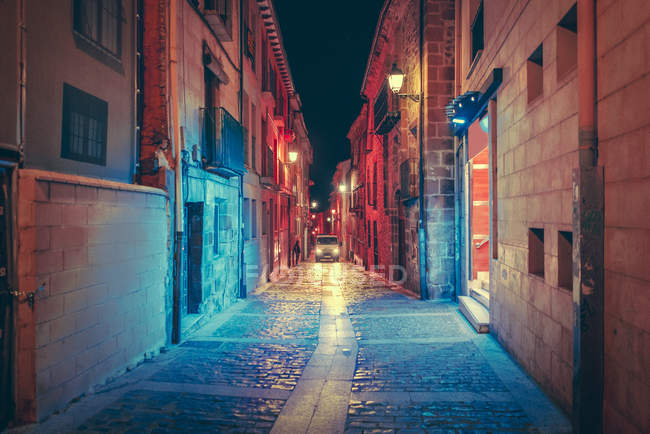 Perspective view to car riding on illuminated alley in city. — Stock Photo