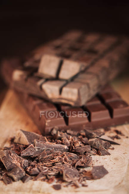 Chocolate chips on wooden board — Stock Photo