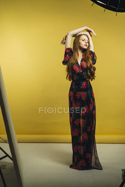 Pretty woman dancing with eyes closed in studio — Stock Photo