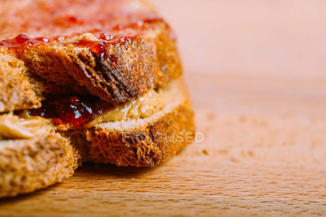 Crop prepared peanut butter and jelly sandwich on table — Stock Photo