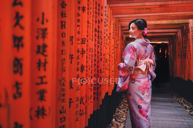Asian woman at red posts — Stock Photo