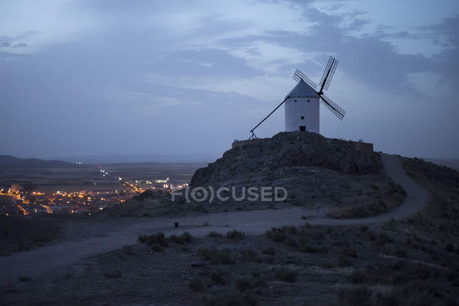 View to historic windmill under cloudy sky in dusk. — Stock Photo