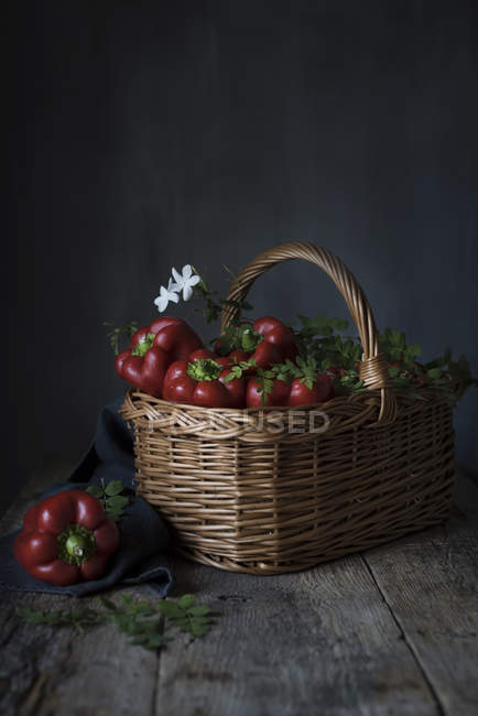 Wicker basket full of red peppers — Stock Photo