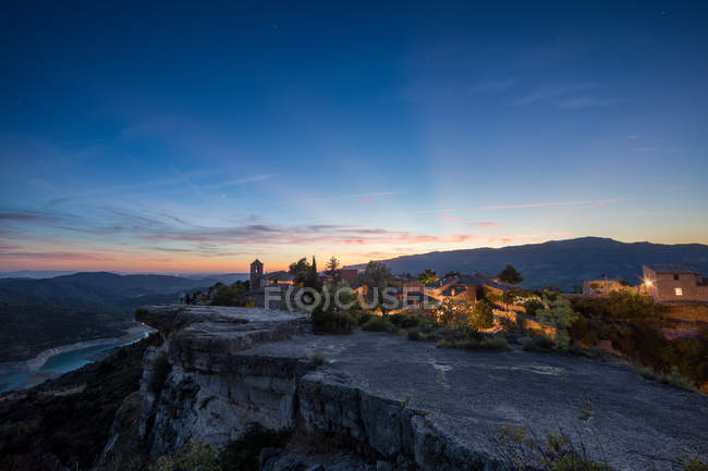 Distant view of village at flat mountain top — Stock Photo