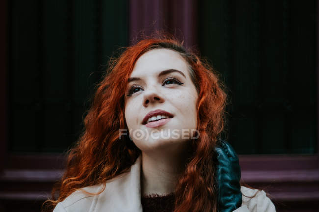 Dreamy redhead woman posing on street — Stock Photo