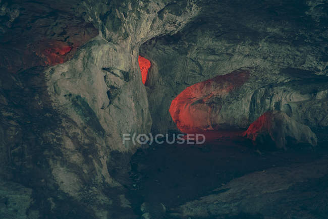 View to illuminated ways and holes in rock cave. — Stock Photo