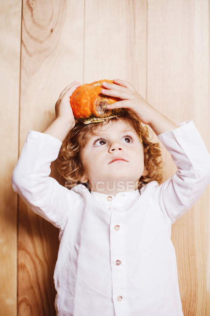 Junge posiert mit Kürbis auf dem Kopf — Stockfoto