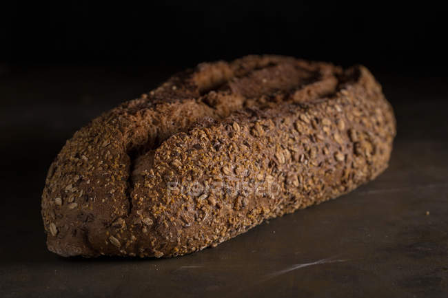 Крупный план свежеиспеченного хлеба на тёмном столе — стоковое фото