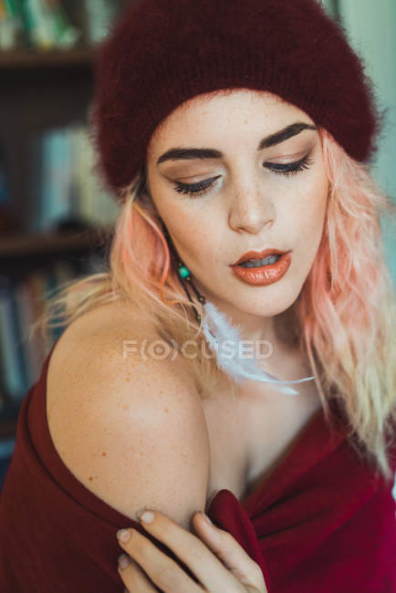 Woman with pink hair showing shoulder at camera — Stock Photo