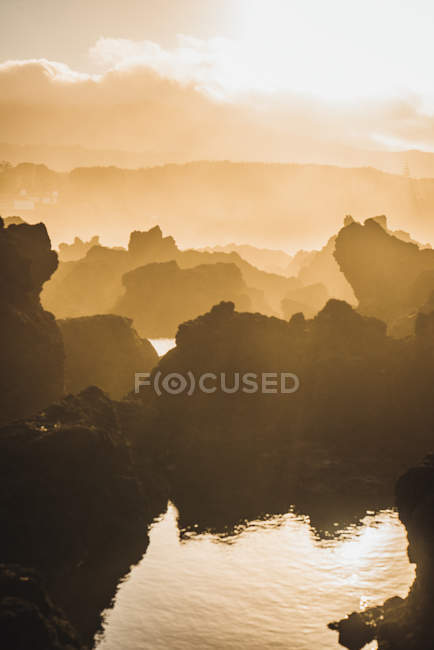 Pastel cliffs silhouettes in sunset lights — Stock Photo