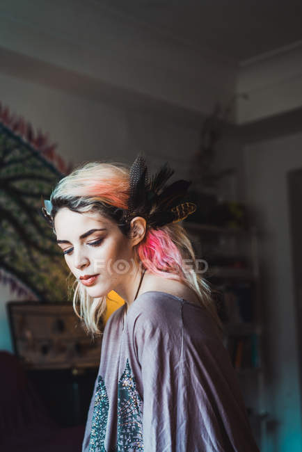 Sensual woman with pink hair looking down — Stock Photo