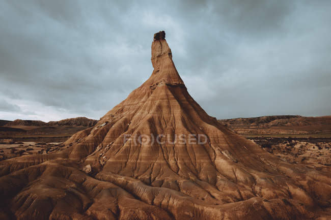 View to tall dry sandy cliff in cloudy day. — Stock Photo