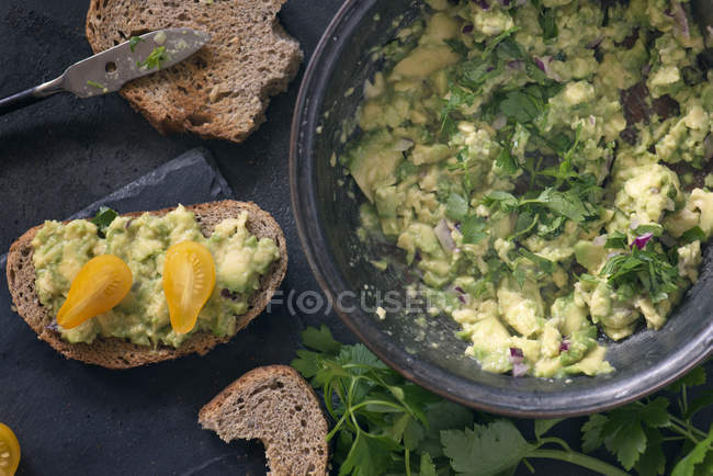From above tasty salad in bowl and toasted bread. — Stock Photo