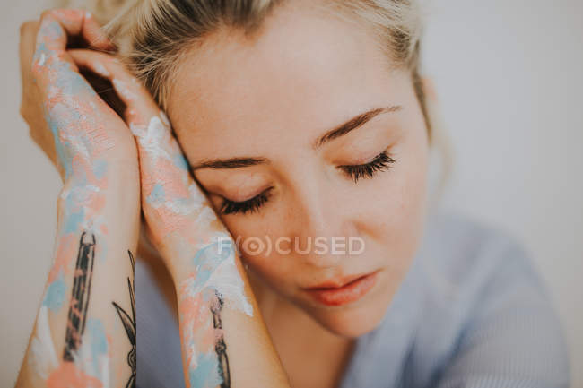 Portrait of blonde woman in male shirt with eyes closed — Stock Photo