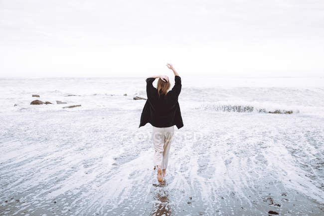 Подвійне опромінення жінки на березі океану і хвилі — стокове фото