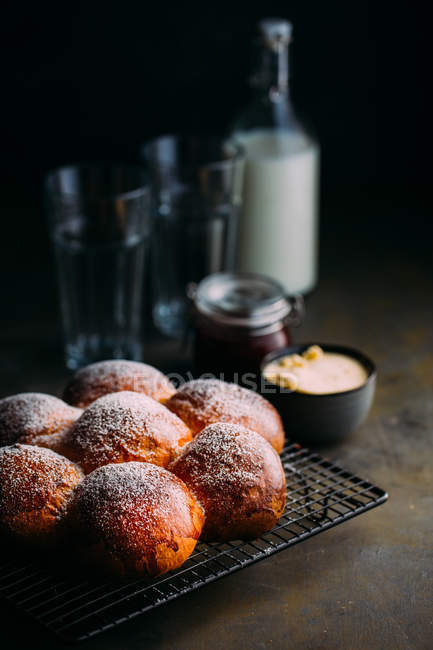 Still life of brioche with icing sugar baking tray — Stock Photo