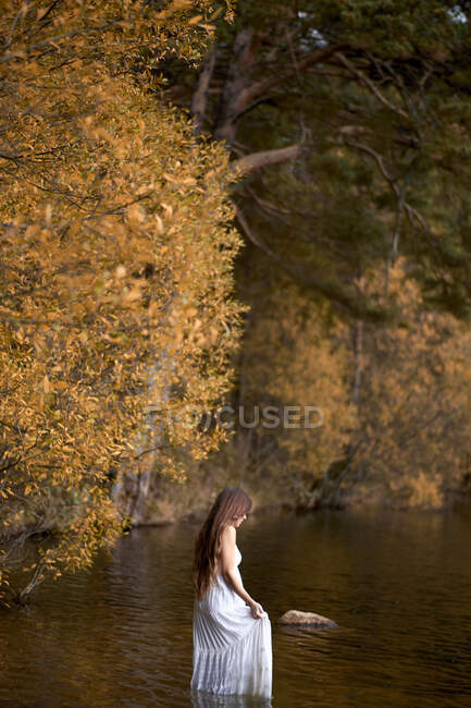 Woman in white dress in water — Stock Photo