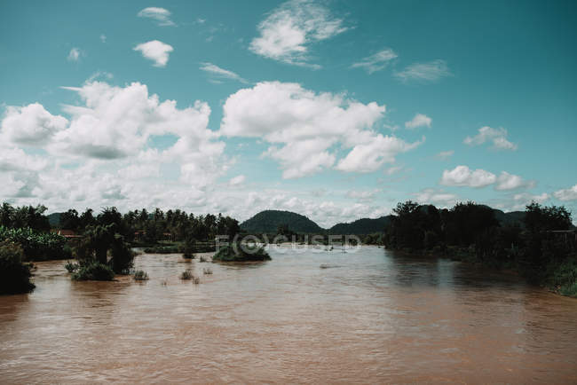 Scenic view to tropical river and bright cloudscape — Stock Photo