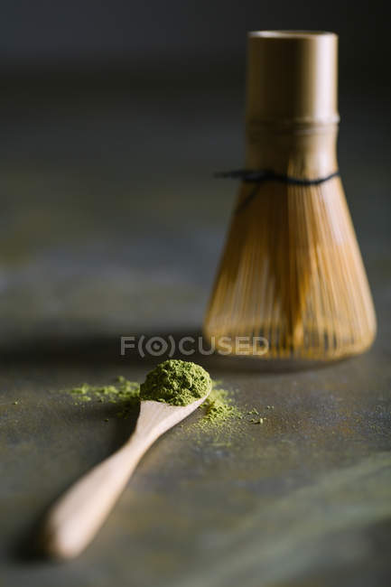 Cuillère en bambou et fouetter avec du thé matcha — Photo de stock